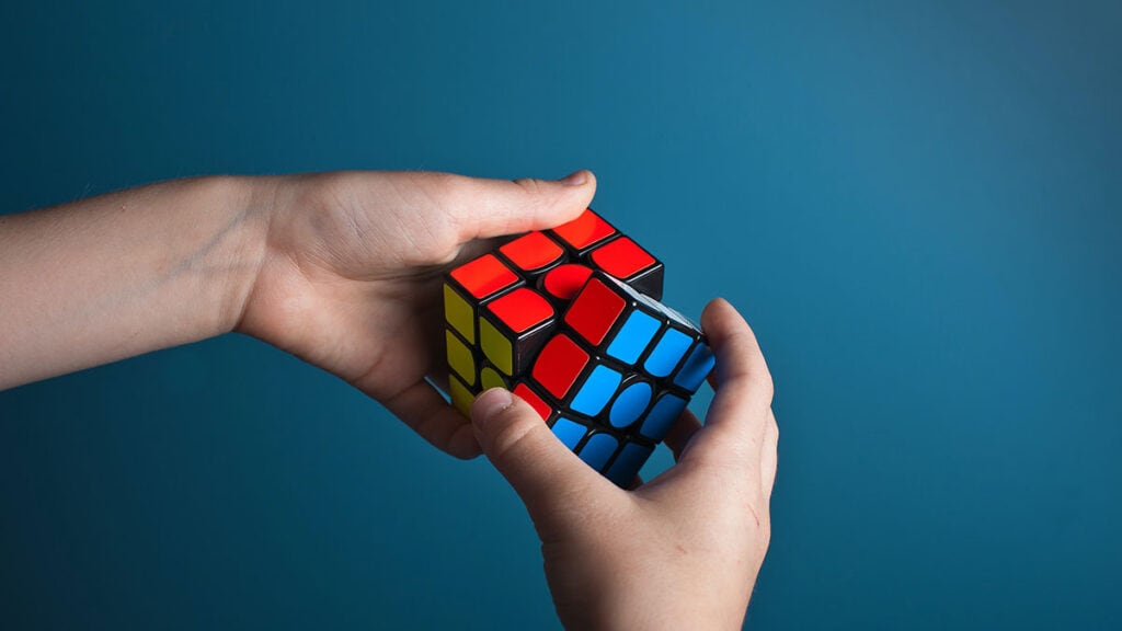 Man trying to solve Rubic Cube