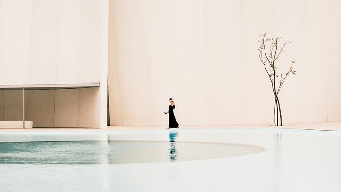 Woman walking beside a Pool
